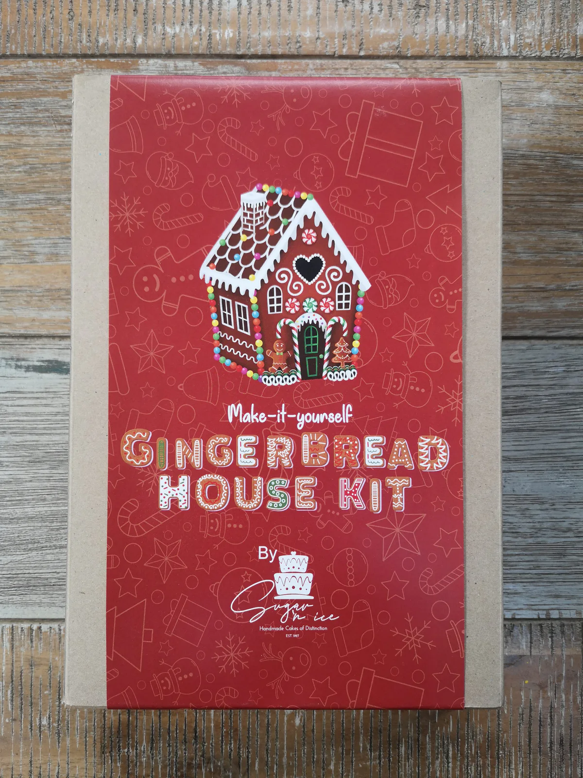 Red Sugar ’n Ice gingerbread house kit box with an illustrated decorated house.